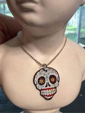 Sugar skull guitar pick necklace.